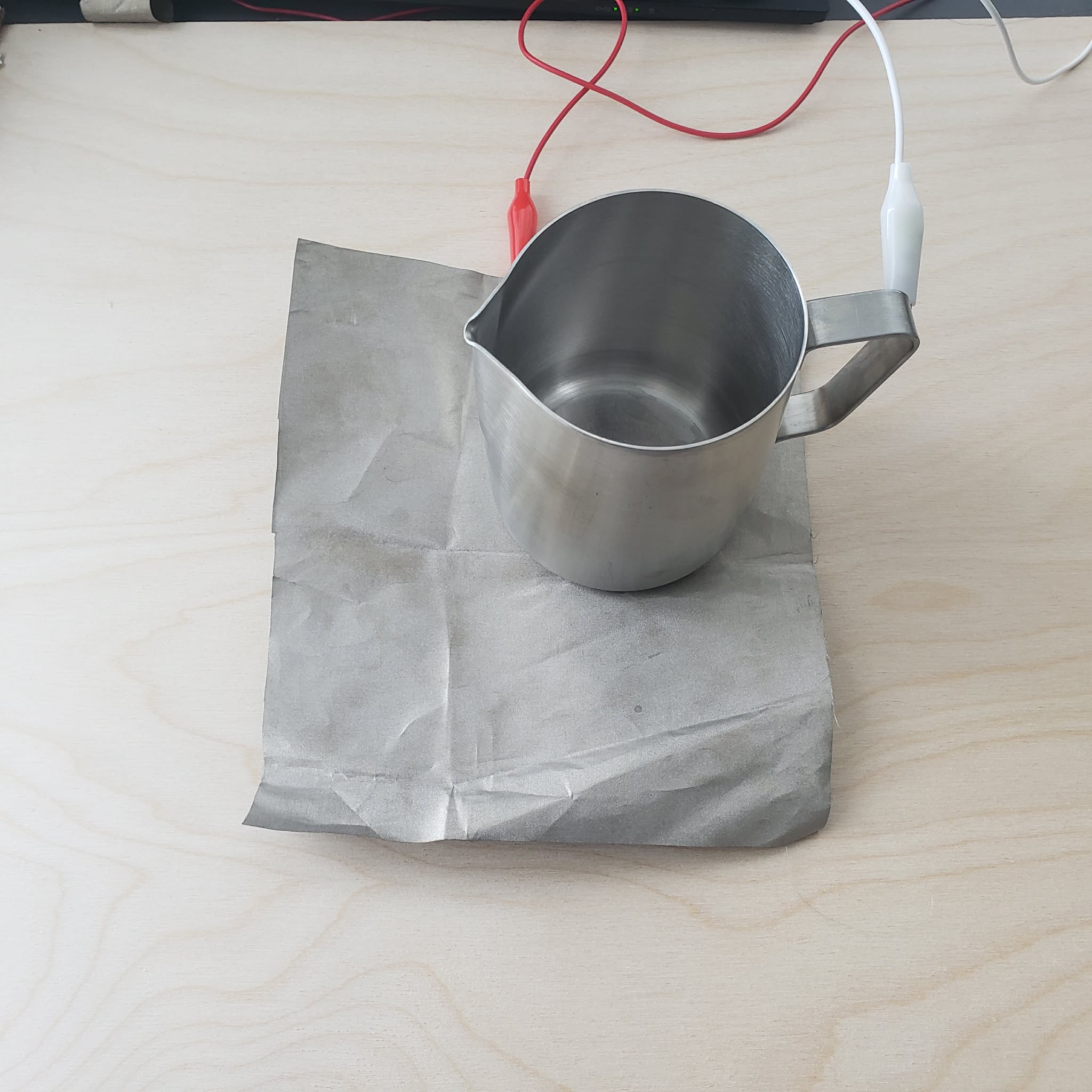 I connect the interaction by putting the metal cup on top of the conductive fabric.