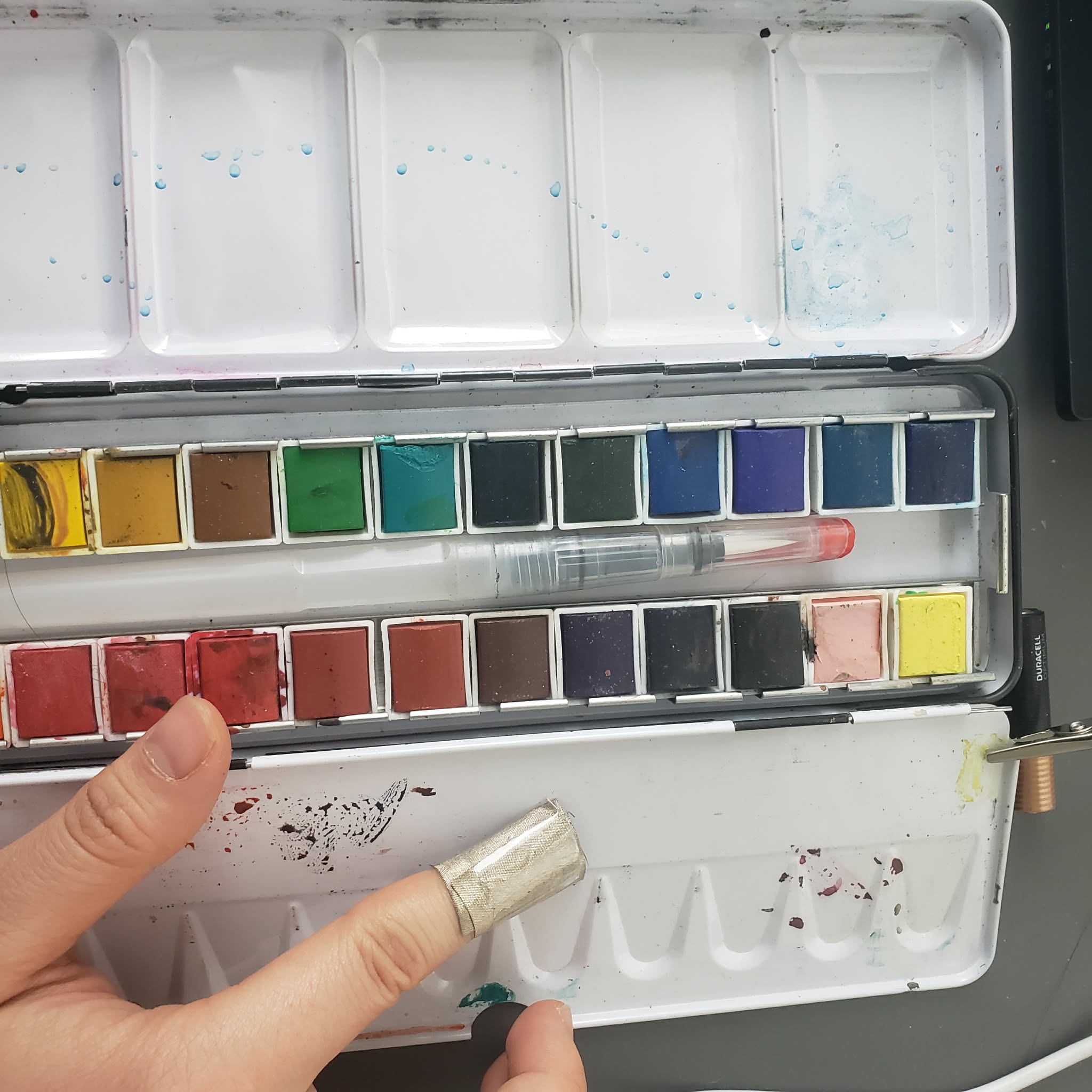 I connect the interaction by wrapping a piece of conductive cloth on my finger and touch the metal paint container. at this pint I honestly just go around and look for whatever is conductive.