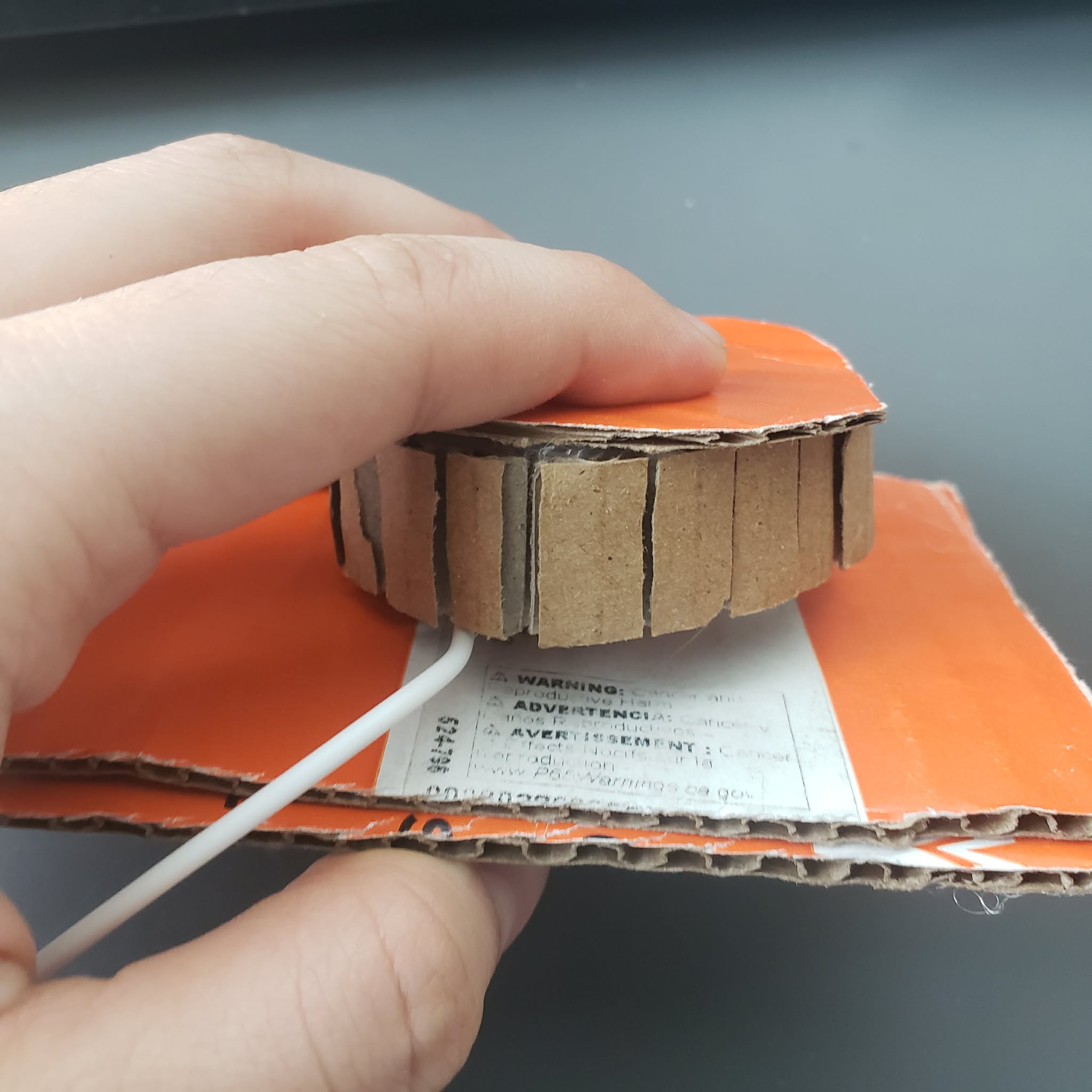 This is a prototype of a pump needle. There is 2 pieces of paper spring that would return the button the its default state if it is pressed.