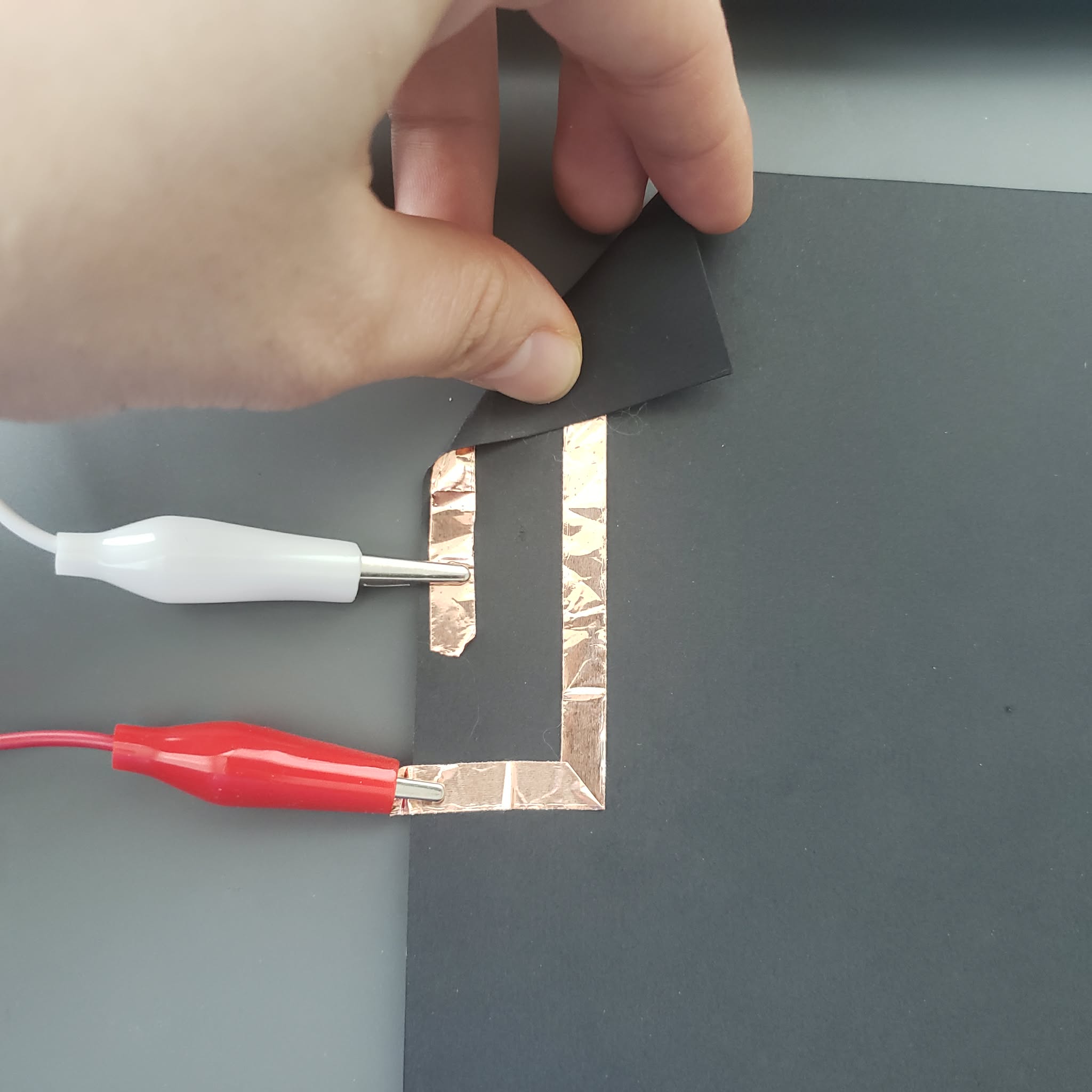 The copper piece are connected by folding the paper.