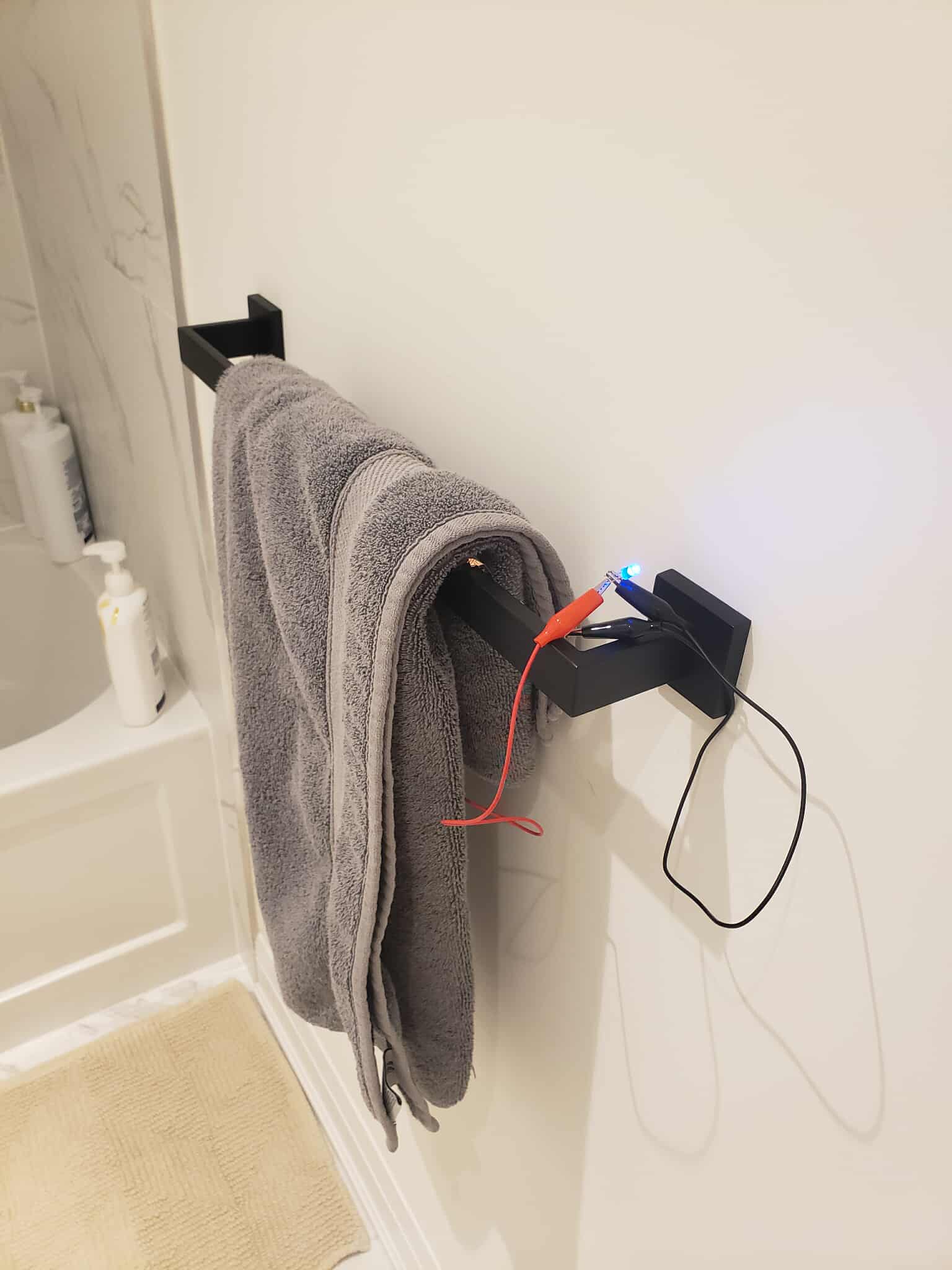 A turned on tower hanger circuit. There is a part of a circuit acting as a switch, which closes when a tower is placed upon it.